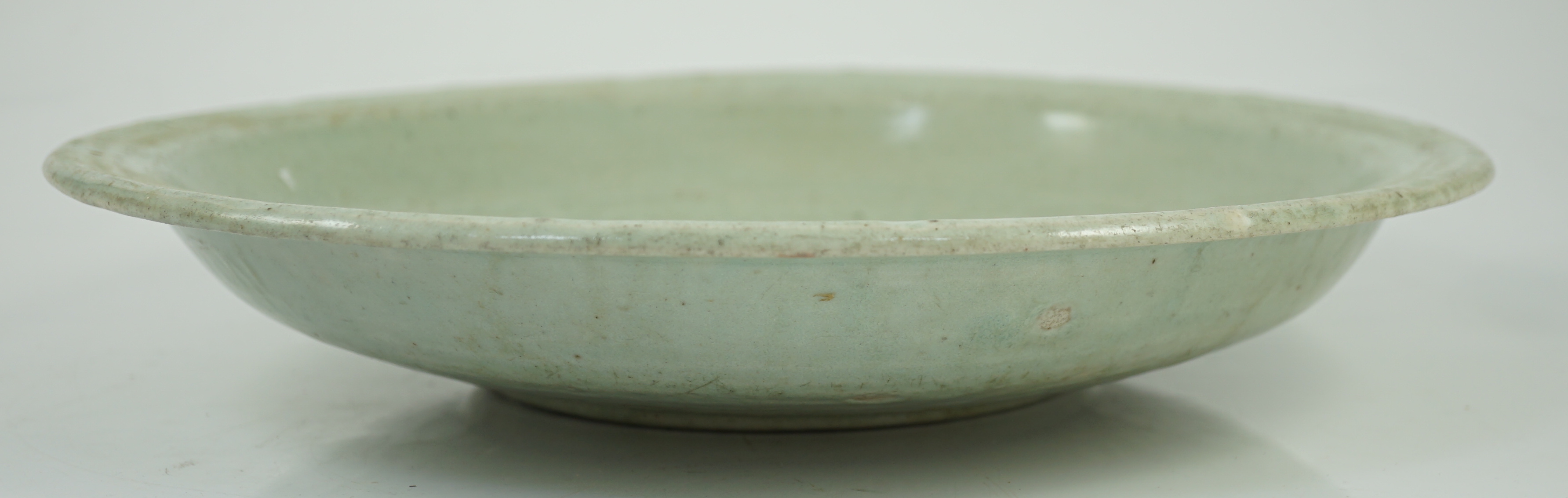 A Chinese Longquan celadon dish, Yuan-Ming dynasty, 13th/14th century, some faults